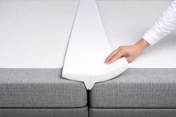 Une cale en mousse pos&eacute;e entre deux matelas
