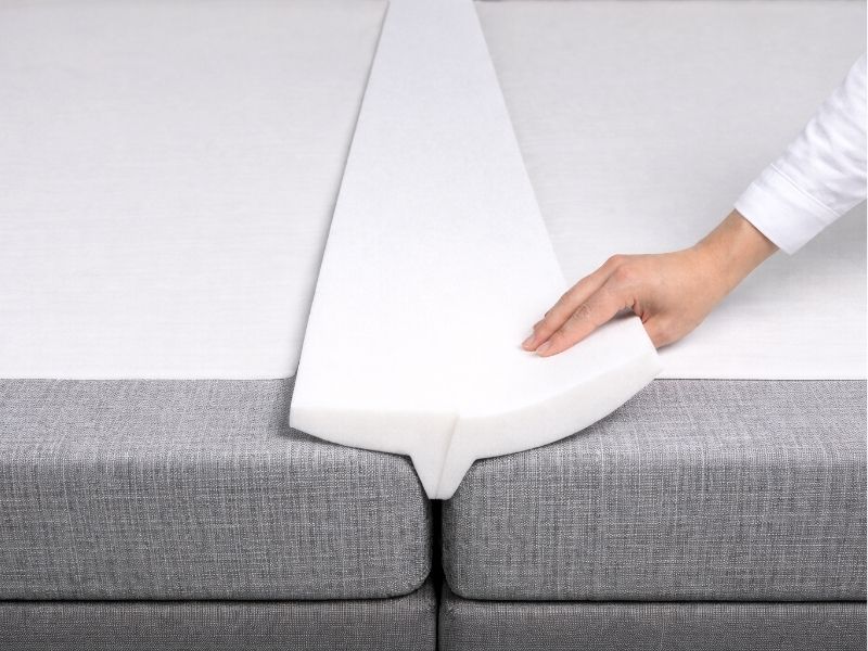 A foam wedge love bridge that sits in the gap between two mattresses